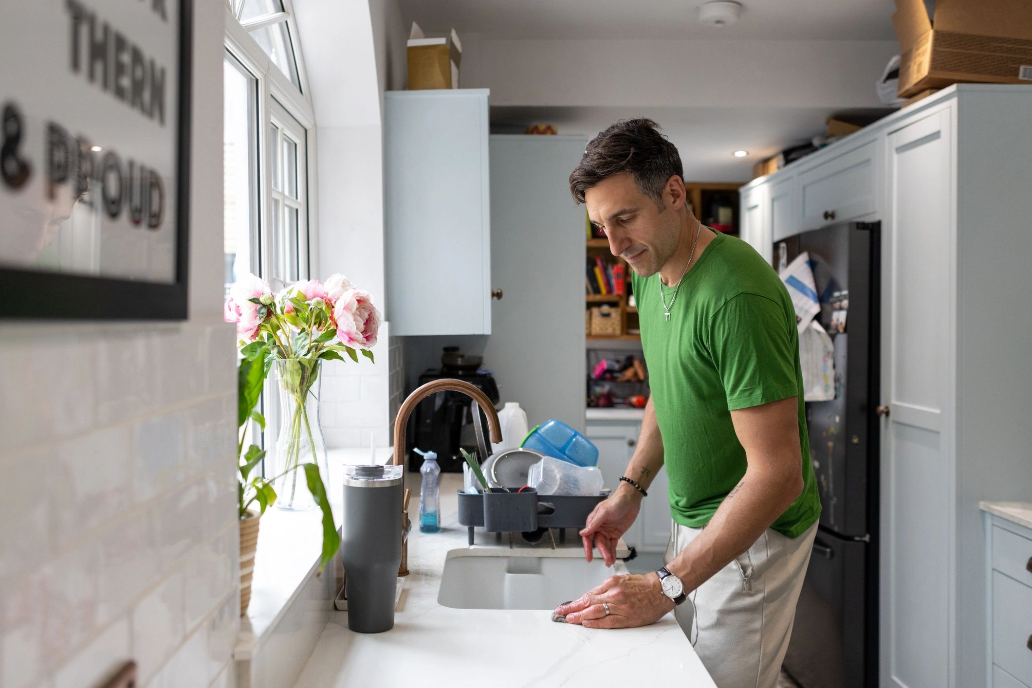Plumber working in a bright kitchen near a sink