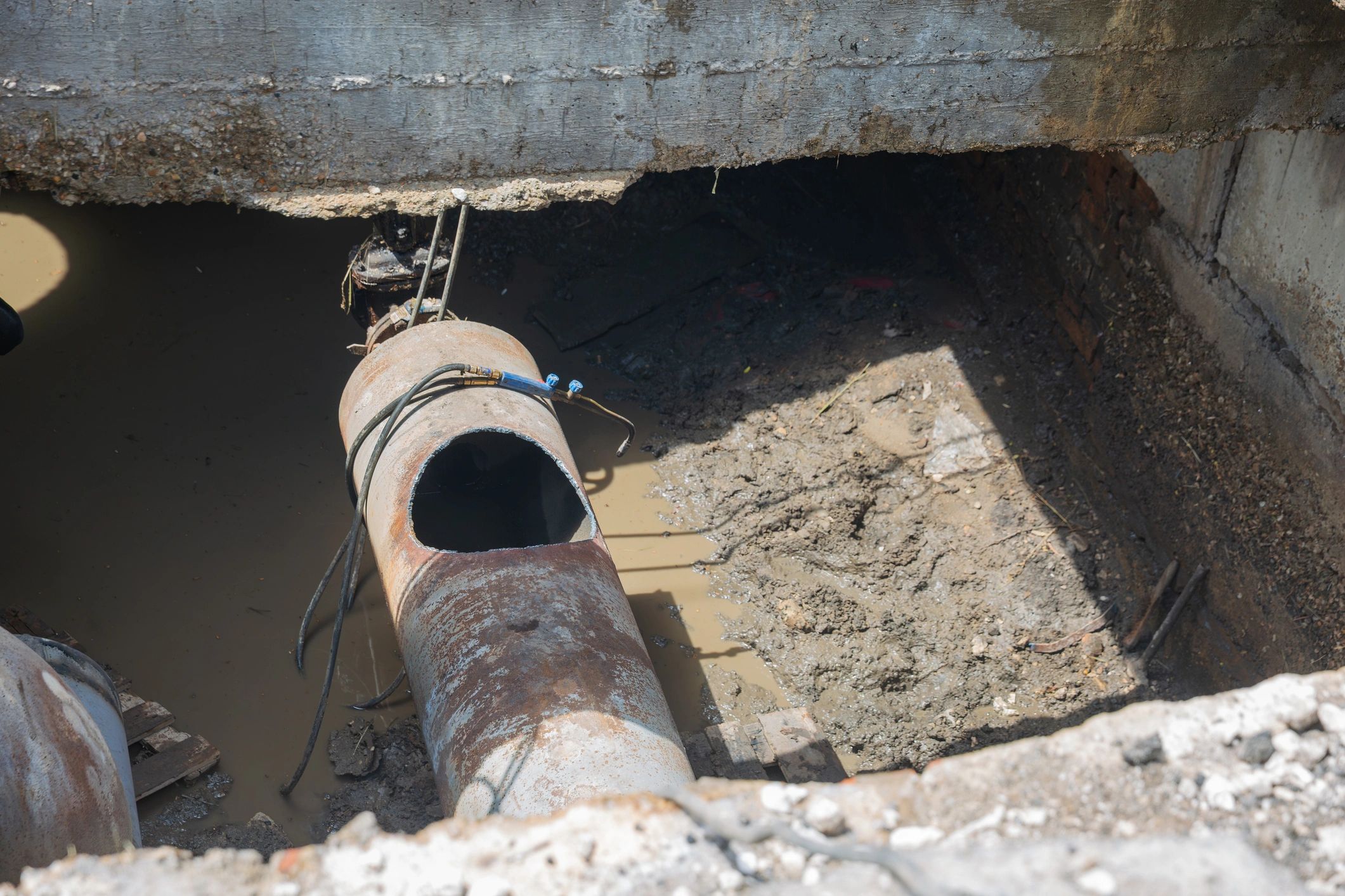 Underground sewer pipe repair work in trench