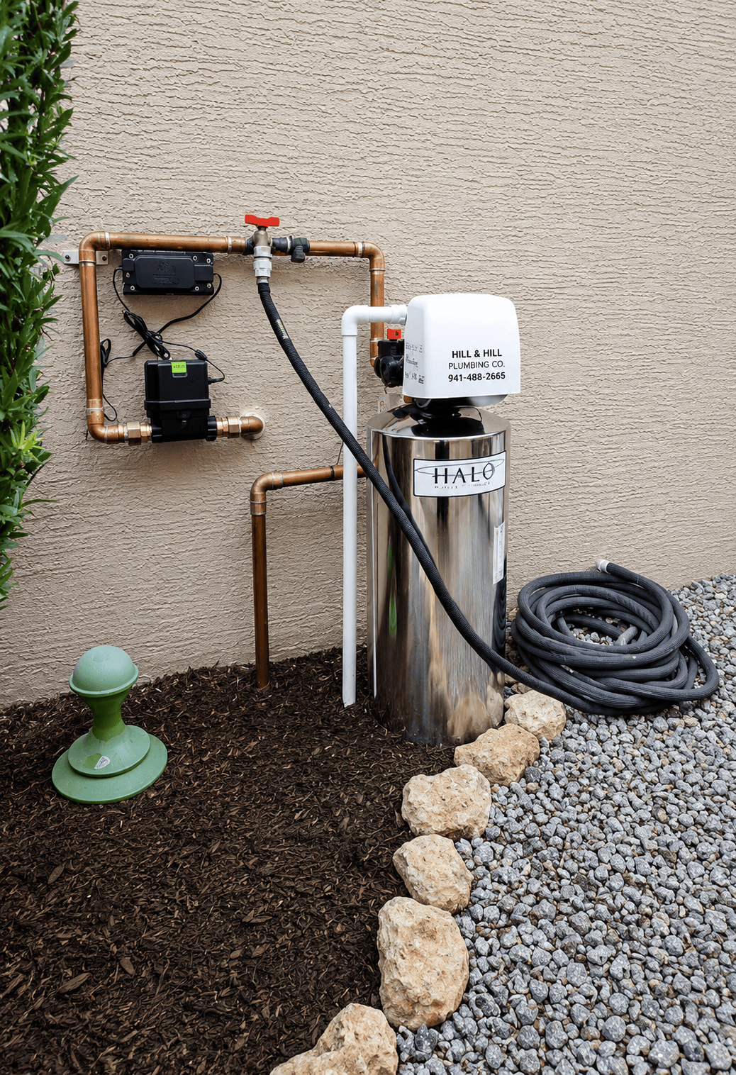 Water treatment service technician working on whole-home filtration equipment